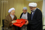 Photos: Flag of Imam Hussain shrine presented to Grand Ayatollah Javadi Amoli