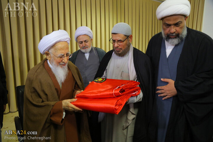 Photos: Flag of Imam Hussain shrine presented to Grand Ayatollah Javadi Amoli