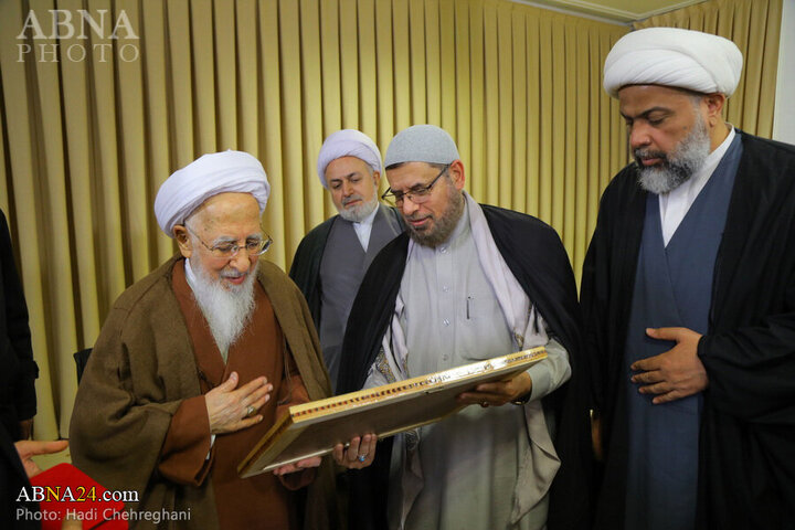 Photos: Flag of Imam Hussain shrine presented to Grand Ayatollah Javadi Amoli