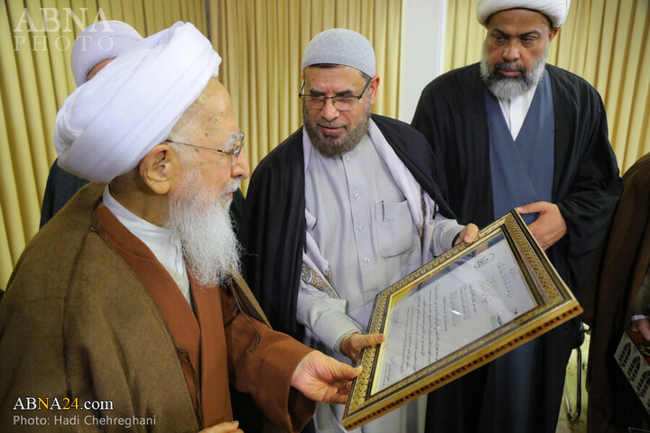 Photos: Flag of Imam Hussain shrine presented to Grand Ayatollah Javadi Amoli