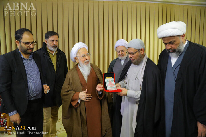 Photos: Flag of Imam Hussain shrine presented to Grand Ayatollah Javadi Amoli