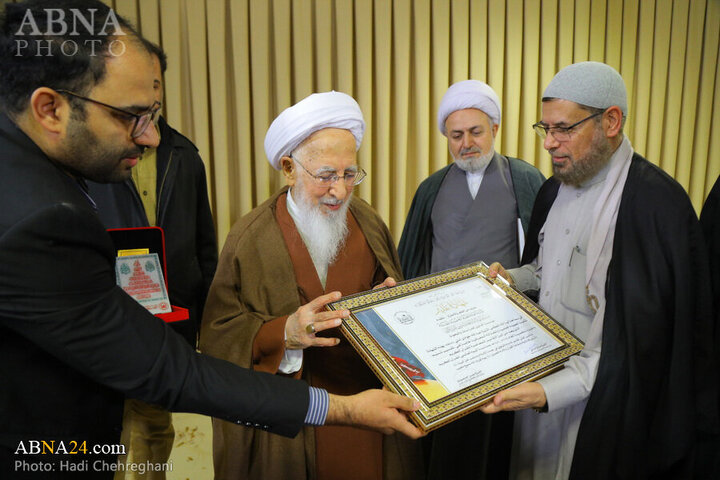 Photos: Flag of Imam Hussain shrine presented to Grand Ayatollah Javadi Amoli