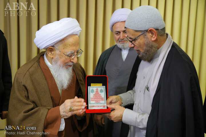 Photos: Flag of Imam Hussain shrine presented to Grand Ayatollah Javadi Amoli