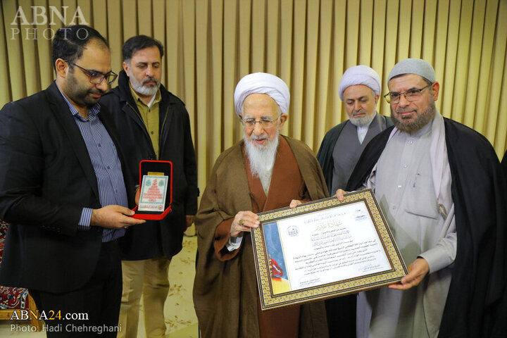 Photos: Flag of Imam Hussain shrine presented to Grand Ayatollah Javadi Amoli