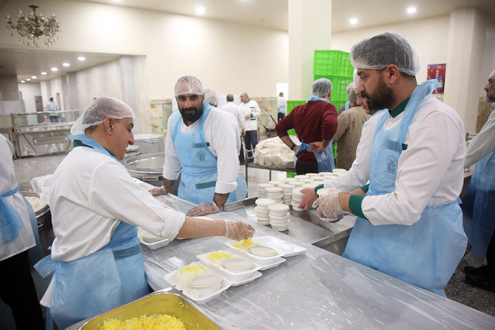تلاش خادمان مهمانسرای حرم بانوی کرامت برای بستهبندی افطاری گرم حضرتی