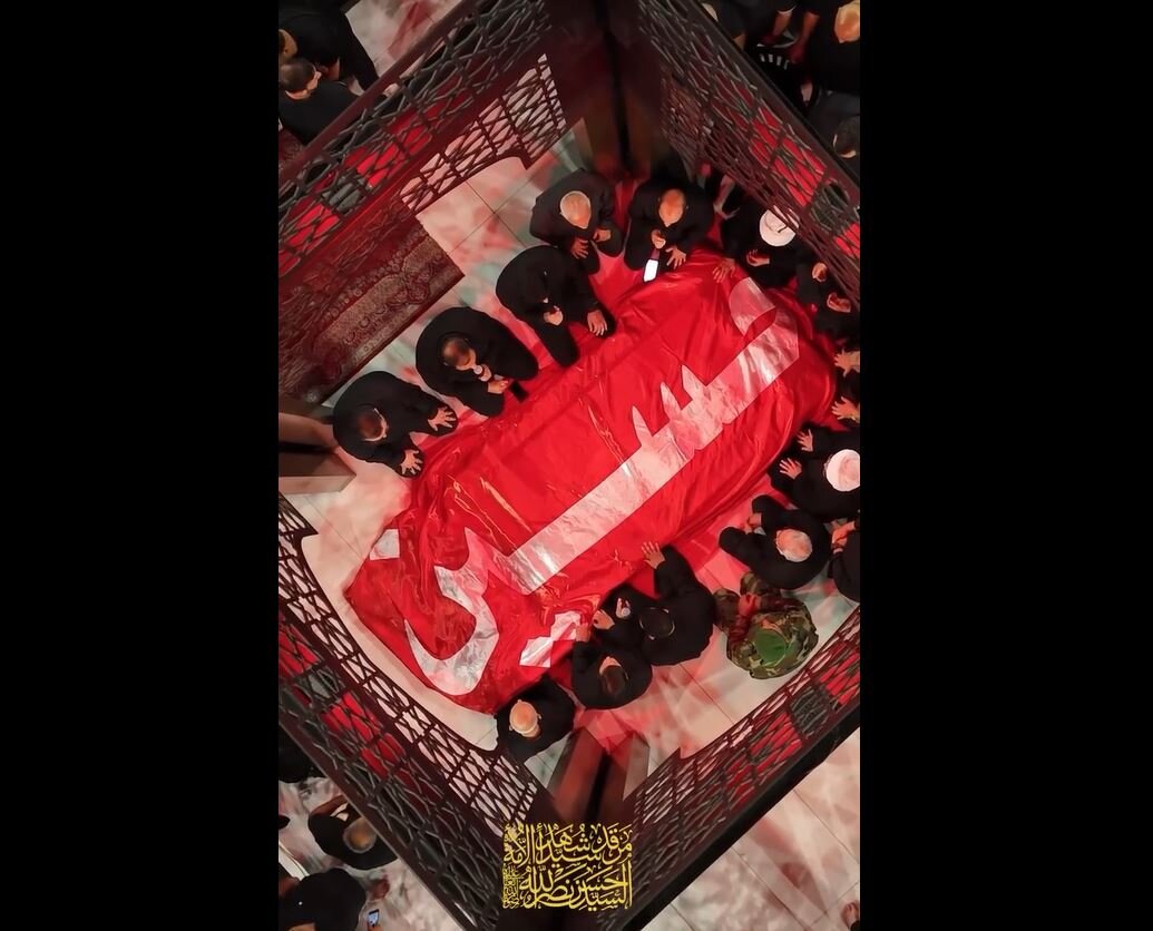 Video: Flag of holy shrine of Imam Hussein placed over tomb of martyr Sayyed Nasrallah
