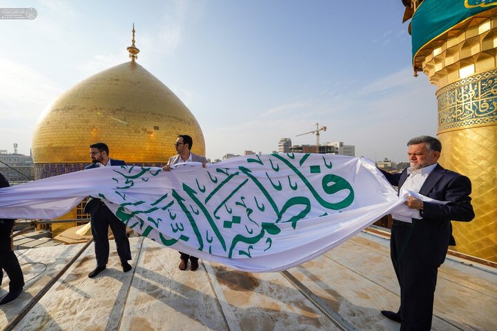 تقرير مصور/ رفع راية «السلام على فاطمة الزهراء» فوق قبة أمير المؤمنين (ع) في النجف الأشرف
