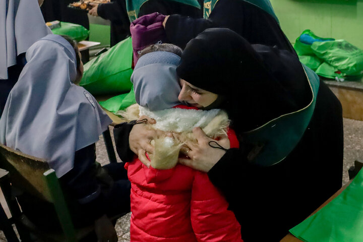 Photos: Distribution of jackets, cultural items by servants of Imam Reza holy shrine