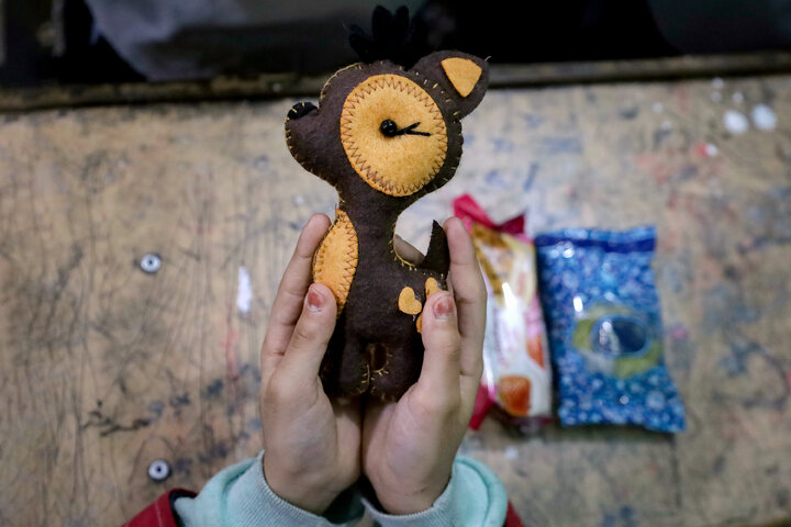 Photos: Distribution of jackets, cultural items by servants of Imam Reza holy shrine