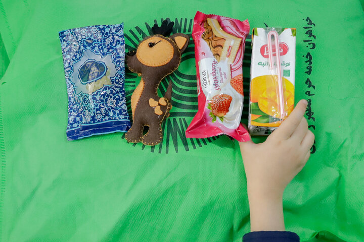 Photos: Distribution of jackets, cultural items by servants of Imam Reza holy shrine