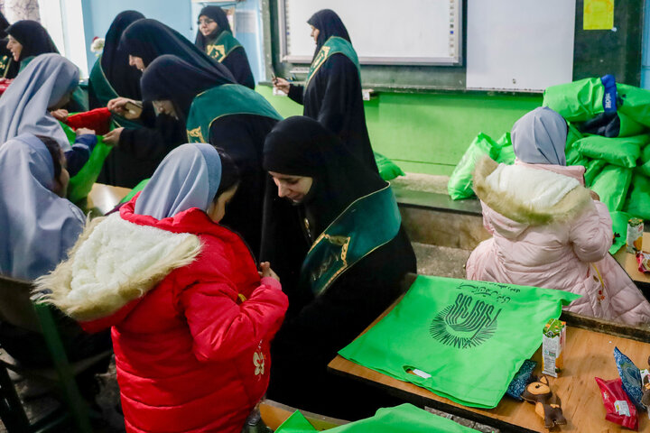 Photos: Distribution of jackets, cultural items by servants of Imam Reza holy shrine