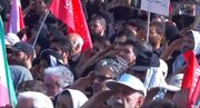 Video: People at Tehran Mosalla recite national anthem with a military salute