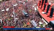 Video: A slow ceremonial circuit of martyr‑leader’s vehicle around Azadi Square as crowds surge in from all directions