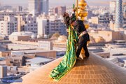 Photos: Imam Reza flag changed on occasion of Rabi' al-Awwal