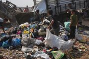 Photos: Displaced Gazans search through trash for fuel to cook food