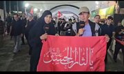 ABNA Reporters Ali and Zainab Explain Meaning of Red Flag "Ya Lisarat Al Hussain" on Najaf to Karbala Path