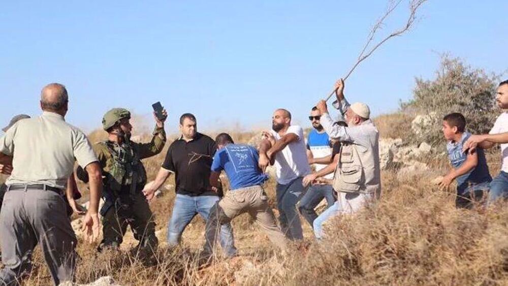 Israeli settlers attack Palestinian homes and olive farmers in West Bank
