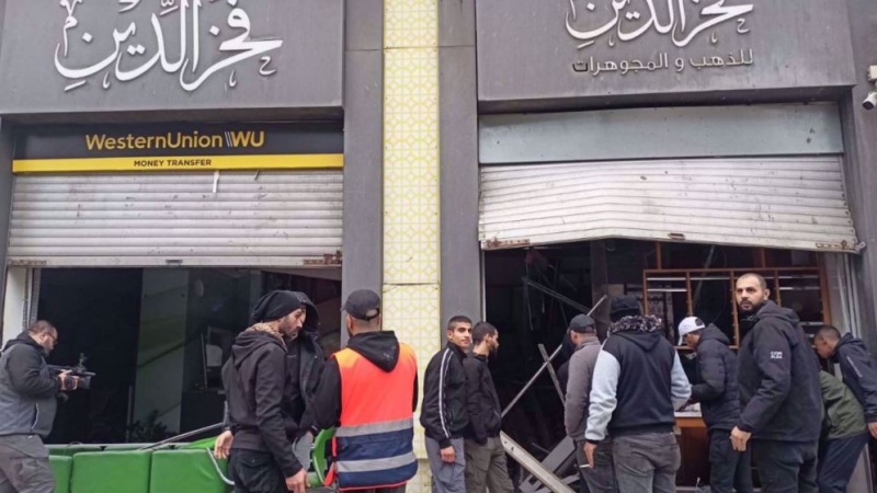  Zionist enemy raid West Bank money exchange offices , seize millions of dollars