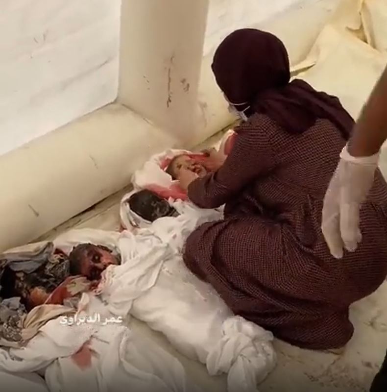 GRAPHIC: Bereaved Gazan mother wipes blood-stained faces of her slain children for their funeral