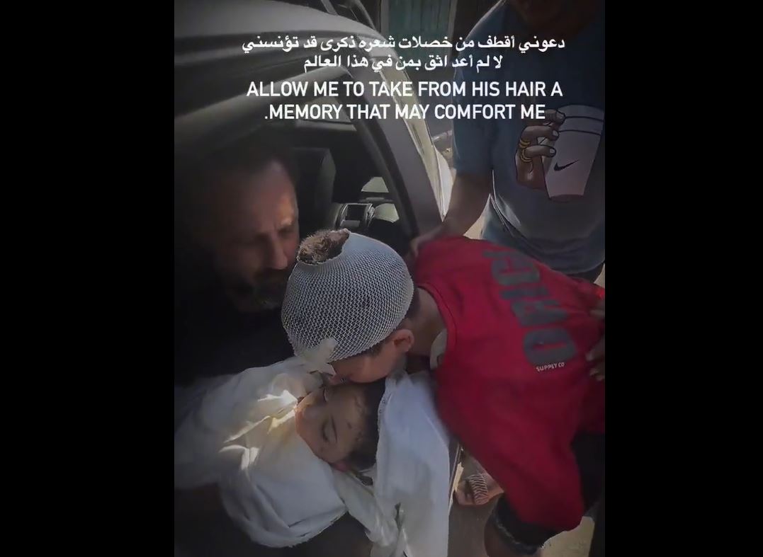 Video: Palestinian child asks his father to take a strand of hair from his martyred brother's head 