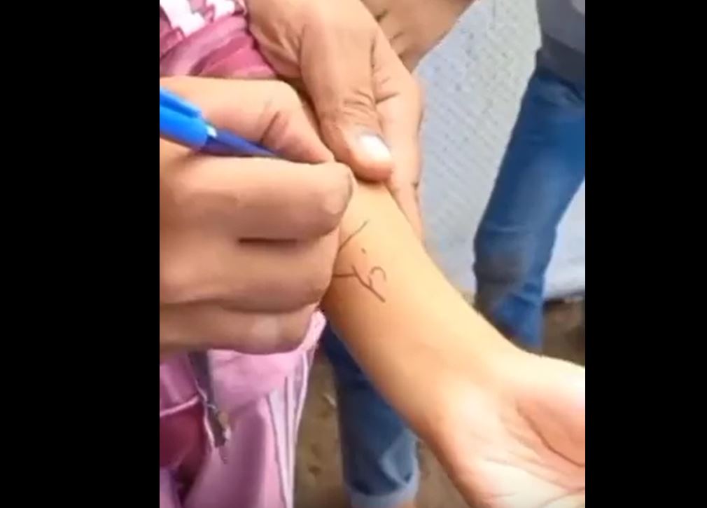 Video: Gaza children write their names on their arms to be identified easier if killed at Israeli airstrikes