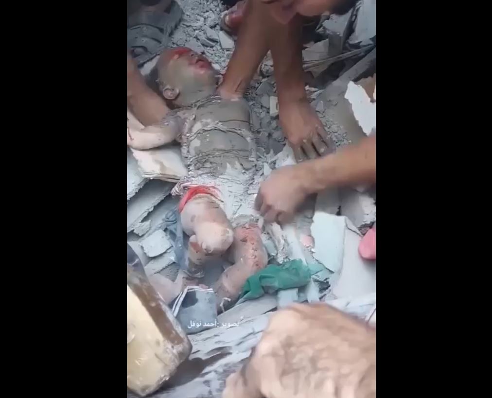 Video: Innocent Palestinian baby just pulled out alive from rubble in Nuseirat, Gaza this morning