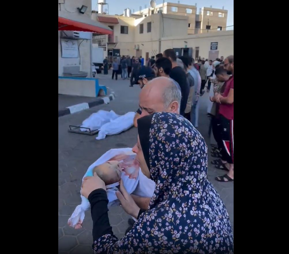 Video: Palestinian parents sorrowfully carry their lifeless child killed in Israeli airstrike on Gaza
