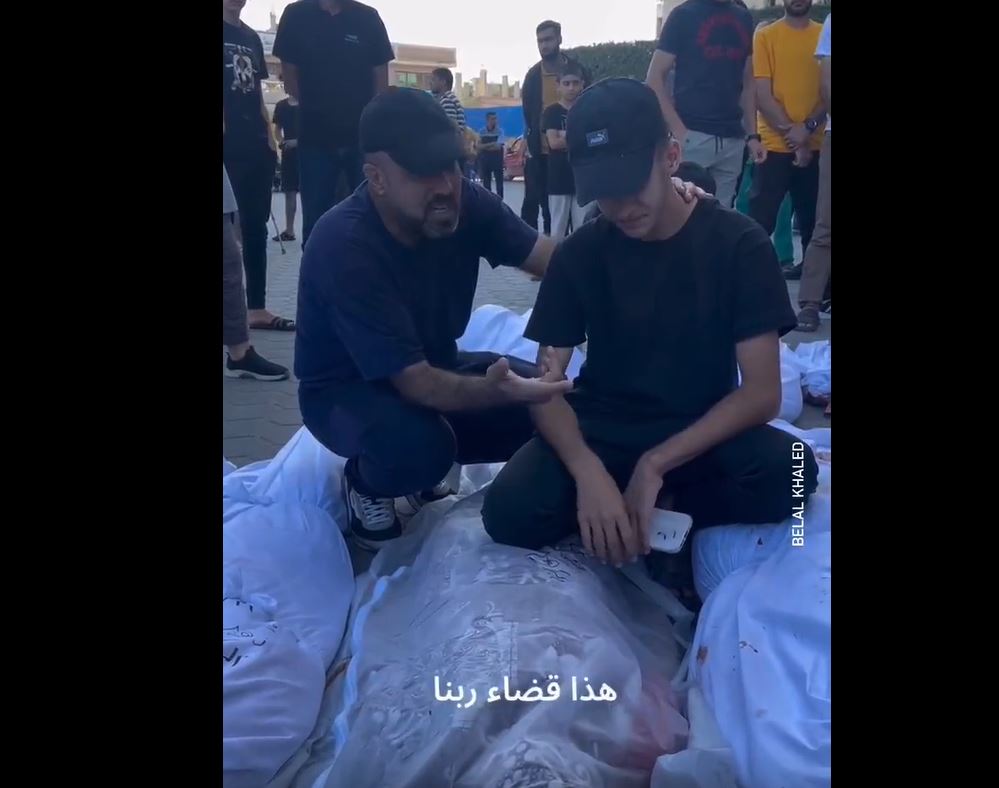 Video: Palestinian father calms his son after their family killed by Israeli airstrikes in Gaza