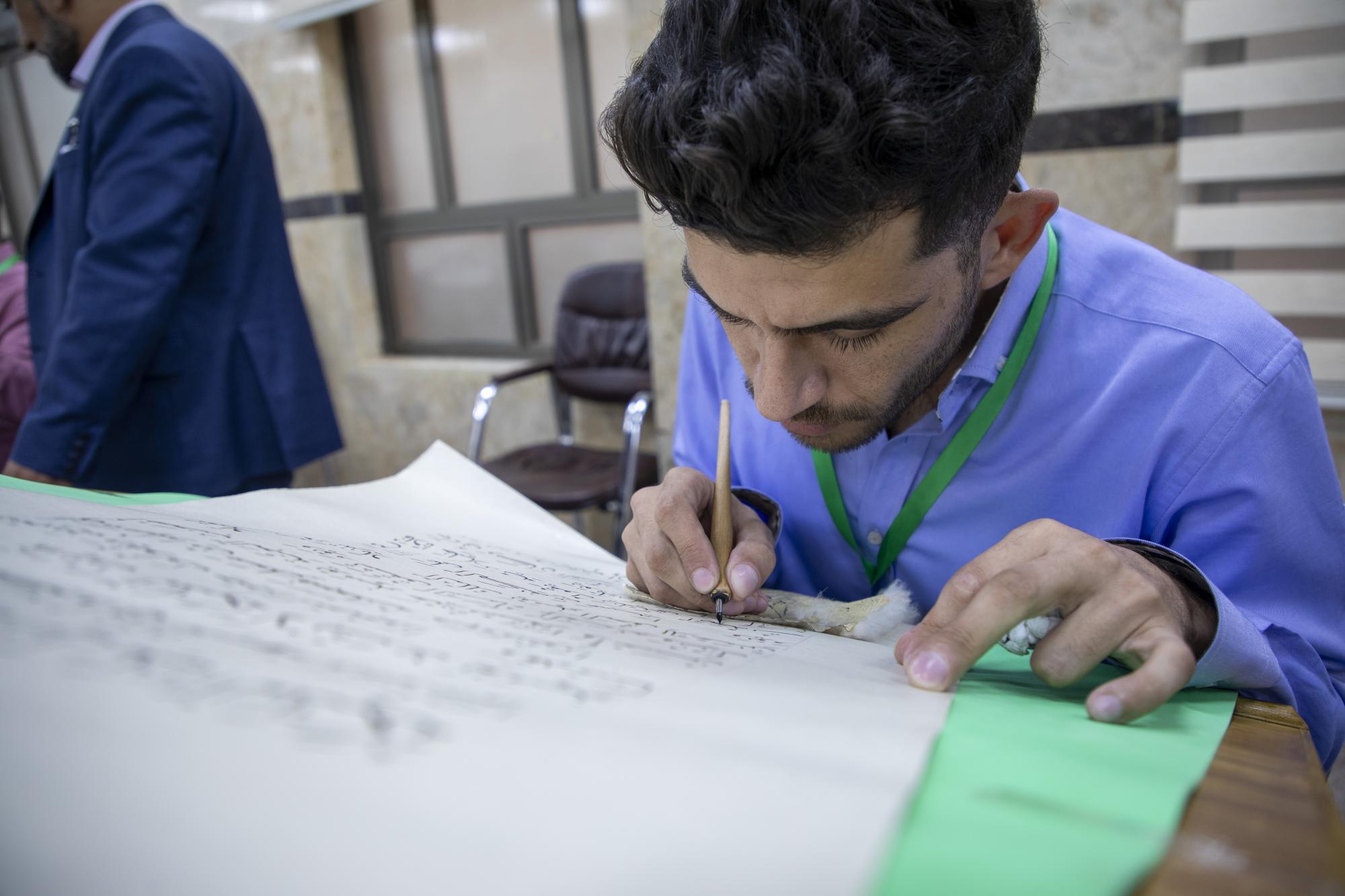 Within Thaqalayn Competition, calligraphers finish writing a page from Holy Quran (+Photos)