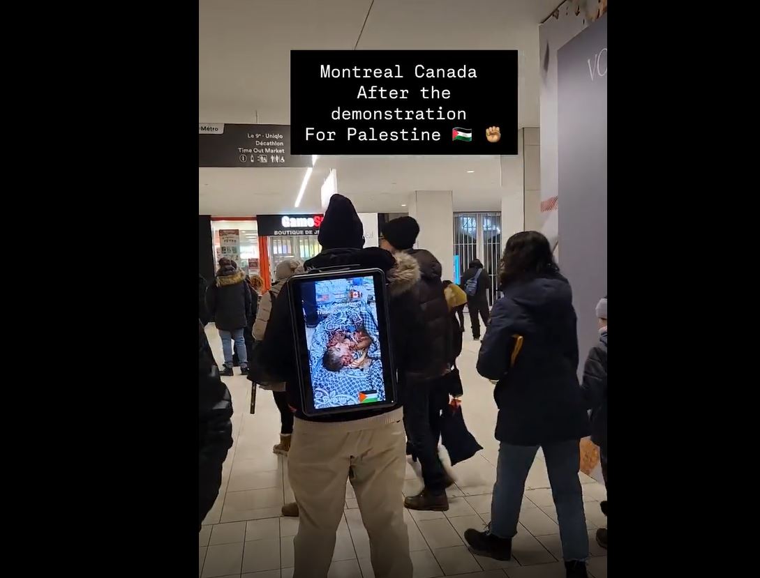 Video: An activist carried a small screen on his back in Montreal, Canada displaying Isreali war on Gaza 