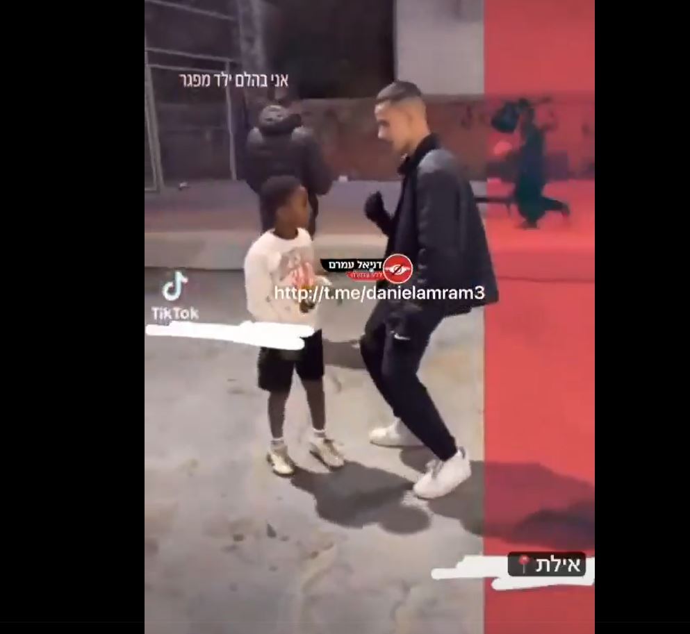 Video: An Israeli racist settler while laughing spits on a young Ethiopian kid 