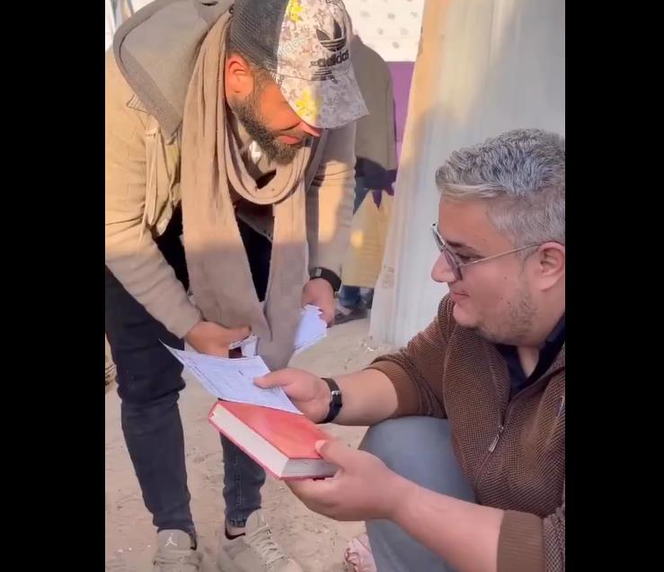 فيديو | في خطوة إيمانية.. فلسطيني يوزع نسخا من المصحف الشريف بين النازحين في غزة