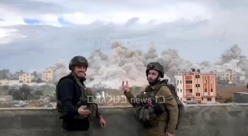 Cursed Zionist soldiers smoking cigarette while blowing an enter residential block in Gaza