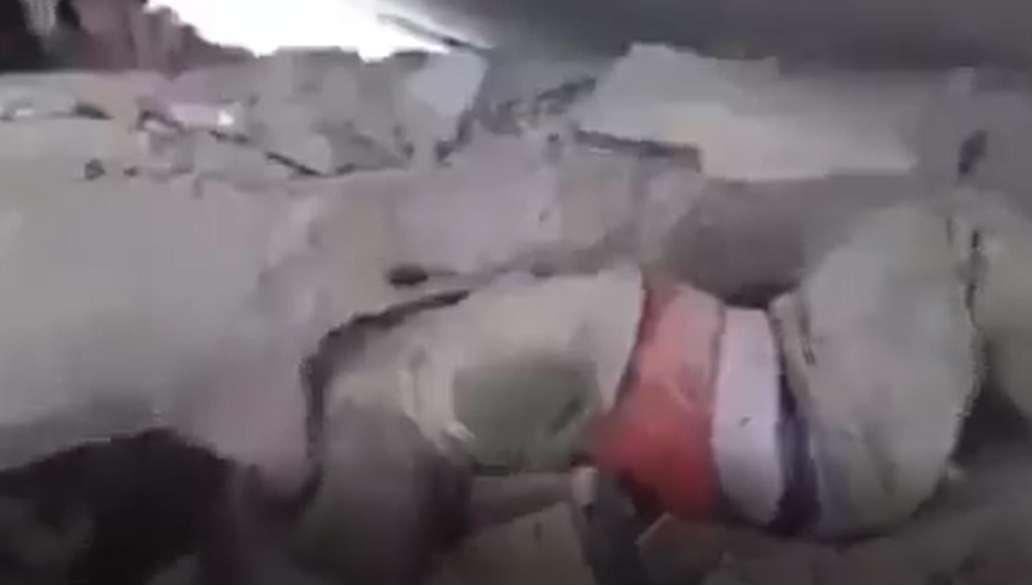 Video: Head of a Palestinian child get stuck under rubble following Israeli airstrike in Gaza