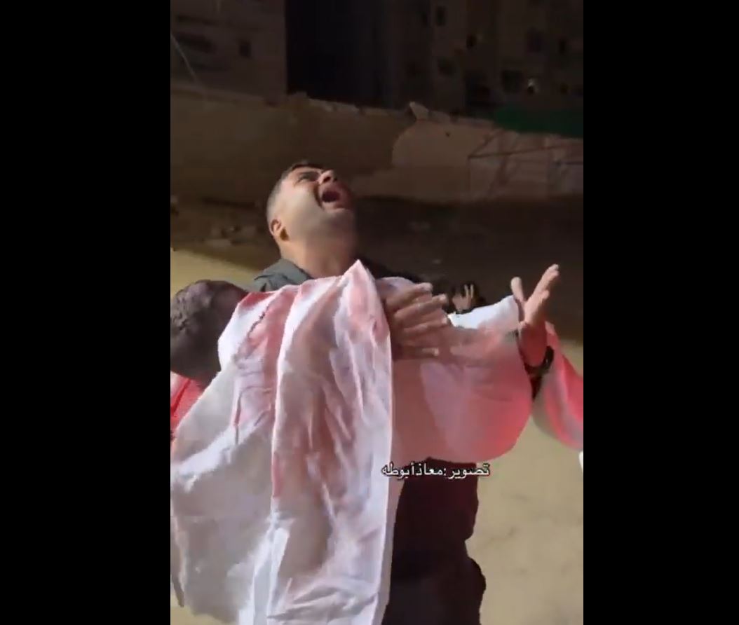 A heart-wrenching scene of a Palestinian father recognizing his slain child martyred in Israeli airstrike in Khan Younis 