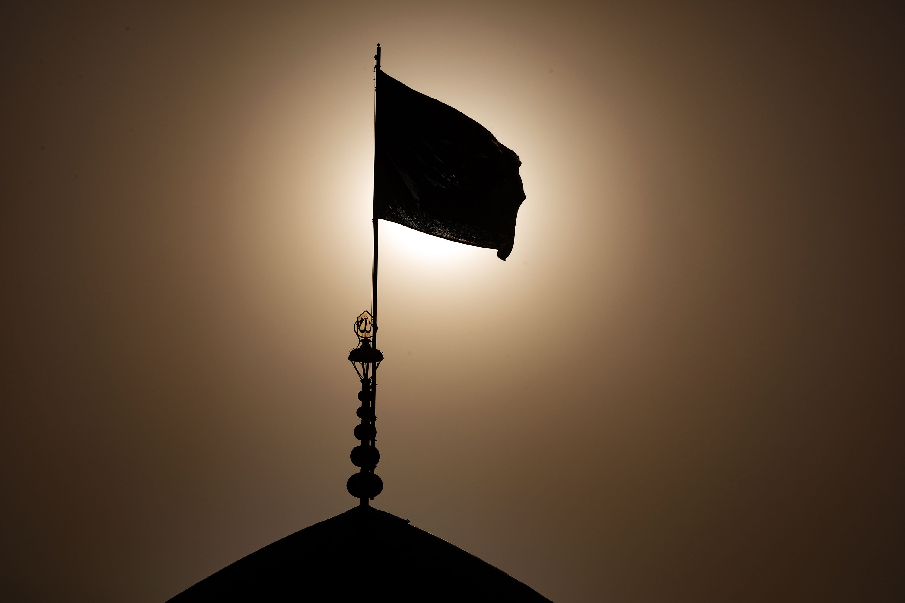 Photos: Astan Quds Razavi hoists black flag over shrine's dome over Hazrat Masoumeh's demise anniversary