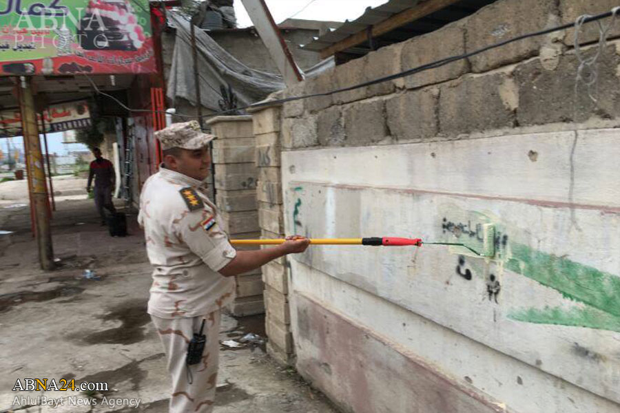  پاک کردن شعارهای داعش در سمت چپ موصل + تصاویر