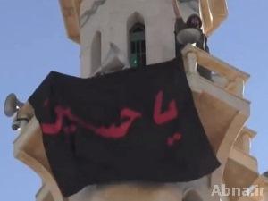 بالفيديو / رفع راية مرقد الإمام الحسين (ع) على مسجد الإمام الحسن (ع) في القصير