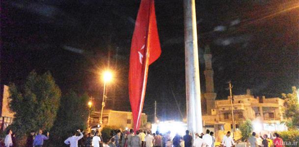 Iraqi citizens raise a 276 square meters Imam Hussein banner