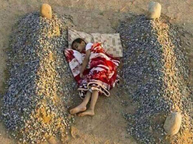 Photo of Syrian boy sleeping between parents' graves was staged