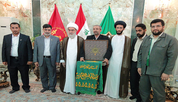 Imam al-Reza holy shrine’s banner presents to Iraq Popular Mobilization Forces