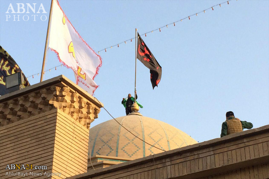 تقرير مصور/ الحشد الشعبي ينصب راية الامام الحسين (ع) على قبة الصحابي "سلمان الفارسي"