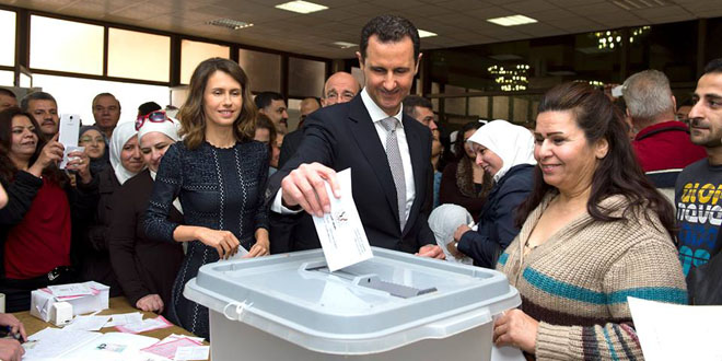 Polls open in Syria parliamentary elections, President Assad, his wife vote in Damascus