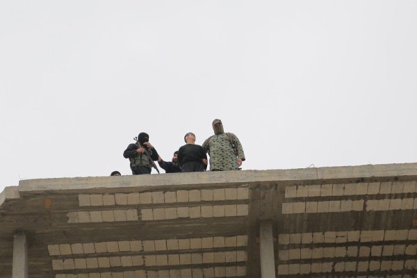 ISIS throw young man from top building & brutally stoned him  / Photos