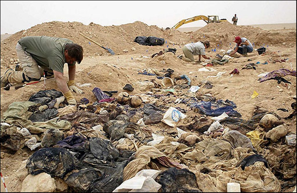 Iraqi volunteer fighters unearth 3 mass graves in Tikrit
