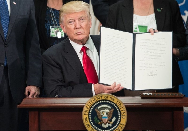 Trump signs new travel ban, exempts Iraq