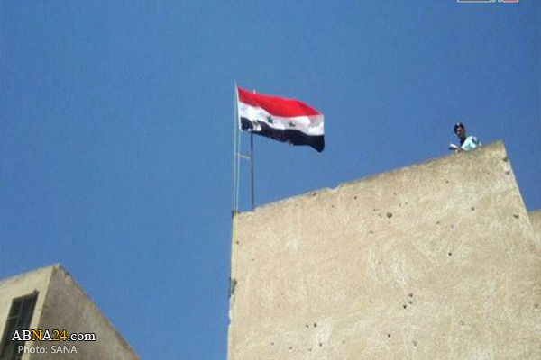 Syrian flag fluttering over Inkhel city in Daraa 