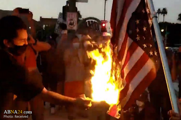 LA protesters block highway, burn US flag over police killing of black man
