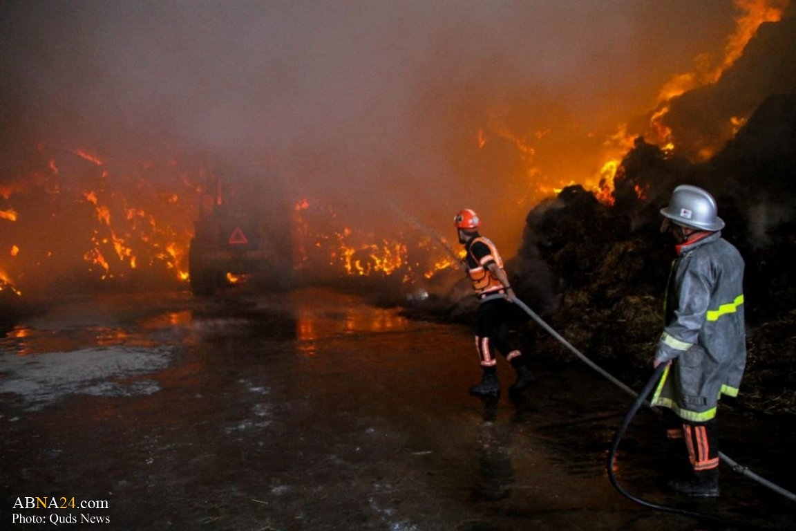 Photos: Extinguishing fire broke out in a fodder warehouse hit by Israeli missile in northern Gaza 