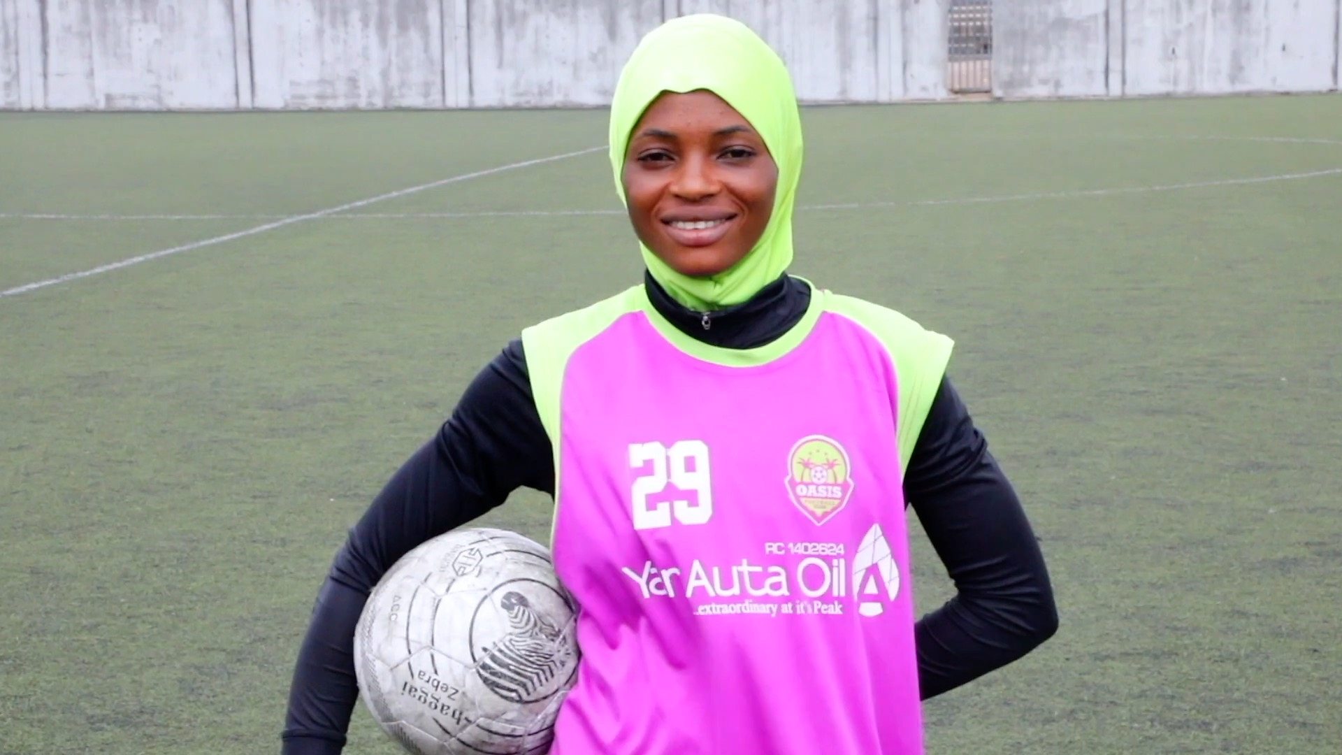 Nigerian Muslim female on playing football with a hijab